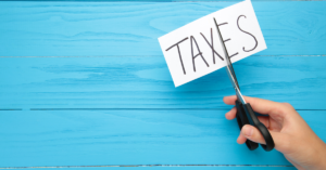 A scissor cutting the word Tax explaining the Marketing Expense Deductions for Content Creators